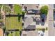 Overhead view of the property highlighting the large, green backyard, the roof, and driveway at 9636 W 71St Pl, Arvada, CO 80004