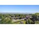 Elevated view showing a neighborhood with varied houses and trees, set against a backdrop of distant mountains at 9636 W 71St Pl, Arvada, CO 80004