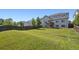 Large backyard featuring a well-maintained lawn, bordered by a wooden fence and the home's exterior at 9636 W 71St Pl, Arvada, CO 80004