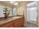 Bathroom with wood vanity and shower with tub at 9636 W 71St Pl, Arvada, CO 80004