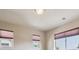Sunlit bedroom with triple window and neutral walls at 9636 W 71St Pl, Arvada, CO 80004