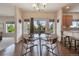 Bright dining area with hardwood floors, a chandelier, and scenic outdoor views at 9636 W 71St Pl, Arvada, CO 80004
