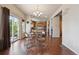 Bright dining area with hardwood floors, a chandelier, and sliding glass doors leading to the deck at 9636 W 71St Pl, Arvada, CO 80004