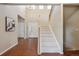 Bright foyer featuring high ceilings, tile flooring, staircase, and a chandelier at 9636 W 71St Pl, Arvada, CO 80004