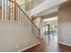 Open foyer area with hardwood floors and staircase leading to the upper level of the home at 9636 W 71St Pl, Arvada, CO 80004
