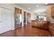 Bright kitchen with stainless steel refrigerator, wooden cabinets, and hardwood floors at 9636 W 71St Pl, Arvada, CO 80004
