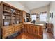Office with hardwood floors, two windows and custom built-in shelving and cabinetry at 9636 W 71St Pl, Arvada, CO 80004