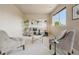 Comfortable sitting room with natural light and neutral colored walls and furniture at 9636 W 71St Pl, Arvada, CO 80004