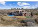 Stunning aerial view of a home with an outdoor pool, sprawling land, and mountain views at 2505 Big Bear Cir, Sedalia, CO 80135