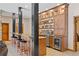 Well-equipped bar area with custom cabinets, beverage fridge, and bar seating at 2505 Big Bear Cir, Sedalia, CO 80135