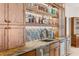 Detailed view of the bar area with granite countertops, sink, and custom cabinets at 2505 Big Bear Cir, Sedalia, CO 80135