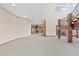 Expansive open basement area with wooden support columns and access to multiple rooms at 2505 Big Bear Cir, Sedalia, CO 80135