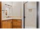 Well-lit bathroom featuring a glass-enclosed shower and wooden vanity with marble countertop at 2505 Big Bear Cir, Sedalia, CO 80135