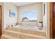 Bright bathroom featuring a soaking tub with a large window offering views at 2505 Big Bear Cir, Sedalia, CO 80135