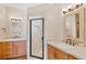 Elegant bathroom with dual vanities, a glass shower, and decorative lighting at 2505 Big Bear Cir, Sedalia, CO 80135