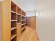 Spacious walk-in closet featuring custom wooden shelving and hardwood floors at 2505 Big Bear Cir, Sedalia, CO 80135