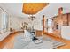 Elegant dining room with wood ceiling, chandelier, hardwood floors, and open floor plan to the living area at 2505 Big Bear Cir, Sedalia, CO 80135