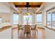 Bright dining room featuring exposed wood beams, a round table with seating for six and beautiful views at 2505 Big Bear Cir, Sedalia, CO 80135