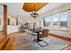 Elegant dining room with wood ceiling, chandelier, and modern decor, with views of a treed landscape at 2505 Big Bear Cir, Sedalia, CO 80135