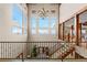 Stunning foyer with high ceilings, a grand chandelier, large windows, and a wrought iron staircase at 2505 Big Bear Cir, Sedalia, CO 80135