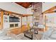 Bright living room featuring vaulted wood ceilings, wood beams, hardwood floors, and a large view window at 2505 Big Bear Cir, Sedalia, CO 80135