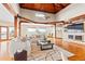 Bright living room featuring vaulted wood ceilings, wood beams, hardwood floors, and a large view window at 2505 Big Bear Cir, Sedalia, CO 80135