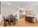 Open kitchen and dining area with stainless steel appliances and hardwood floors at 2505 Big Bear Cir, Sedalia, CO 80135