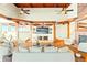 Bright living room featuring vaulted wood ceilings, wood beams, hardwood floors, and a large view window at 2505 Big Bear Cir, Sedalia, CO 80135