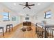 Spacious living room with hardwood floors, TV, and large windows showcasing the outdoor view at 2505 Big Bear Cir, Sedalia, CO 80135