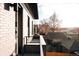 Outdoor balcony overlooking a neighborhood with a brick exterior and black railing at 2753 Curtis St, Denver, CO 80205