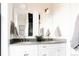 Bathroom with double sinks, modern gold fixtures, and two large mirrors at 2753 Curtis St, Denver, CO 80205