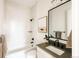 Stylish bathroom featuring a tub/shower combo, large mirror, and modern finishes at 2753 Curtis St, Denver, CO 80205