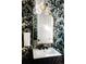 Stylish powder room features designer wallpaper, a modern vanity, and gold-tone mirror at 2753 Curtis St, Denver, CO 80205