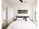 Cozy bedroom features a plush bed, natural light, and modern decor at 2753 Curtis St, Denver, CO 80205