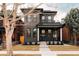 Beautiful exterior view of a dark brick home with a welcoming front porch and manicured lawn at 2753 Curtis St, Denver, CO 80205