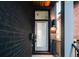 Inviting front entrance features a modern glass door, stylish lighting, and the house number at 2753 Curtis St, Denver, CO 80205