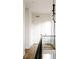 Bright hallway with hardwood floors, black railing, and modern lighting fixtures at 2753 Curtis St, Denver, CO 80205