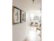 Bright hallway featuring herringbone floors and stylish artwork leading into the living space at 2753 Curtis St, Denver, CO 80205