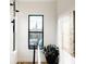 Sunlit hallway with a large window offering views of a church steeple and neighborhood at 2753 Curtis St, Denver, CO 80205