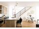 Kitchen and dining area featuring an island with seating and staircase at 2753 Curtis St, Denver, CO 80205