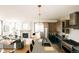 Open-concept layout with a modern kitchen with island seating and view to living room with fireplace at 2753 Curtis St, Denver, CO 80205