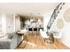 Open living area featuring a modern kitchen, dining area, and staircase at 2753 Curtis St, Denver, CO 80205
