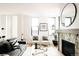 Bright and airy living room with large windows, modern decor, and a cozy fireplace at 2753 Curtis St, Denver, CO 80205