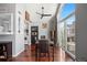 Dining area with hardwood floors, a dark wood table, and kitchen access at 3335 S Monaco Pkwy # D, Denver, CO 80222
