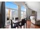 Bright dining area with large windows, deck access, and hardwood flooring, offering great natural light at 3335 S Monaco Pkwy # D, Denver, CO 80222