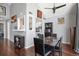 Dining area with hardwood floors, adjacent to kitchen, featuring a marble-top table and modern decor at 3335 S Monaco Pkwy # D, Denver, CO 80222