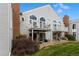 Back exterior view showing patio, grass, and building at 3335 S Monaco Pkwy # D, Denver, CO 80222