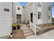 Inviting condo entrance with a small patio, landscaping, and address number 3335 at 3335 S Monaco Pkwy # D, Denver, CO 80222