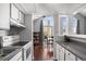 Open kitchen with white cabinets, view of dining area, and access to balcony at 3335 S Monaco Pkwy # D, Denver, CO 80222