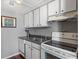 Functional kitchen with white cabinets, essential appliances, and ample storage space, offering a clean aesthetic at 3335 S Monaco Pkwy # D, Denver, CO 80222